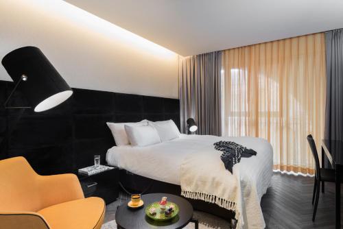 a hotel room with a bed and a table and chairs at Leonardo Boutique Jerusalem in Jerusalem