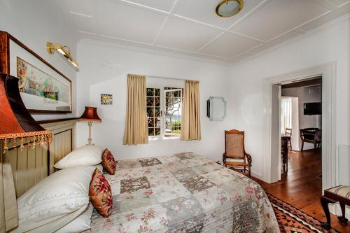 a bedroom with a large bed and a window at Salop House in Fish hoek