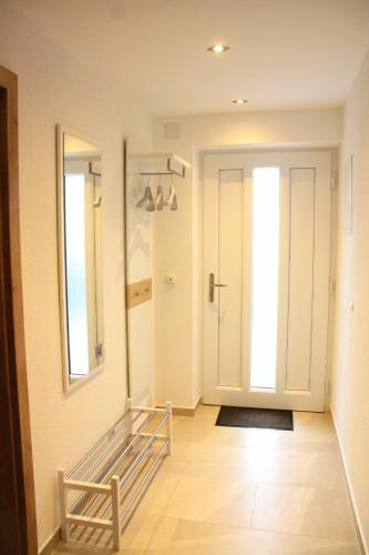 a room with a hallway with a door and a mirror at Apartments Fuchs in Grundlsee