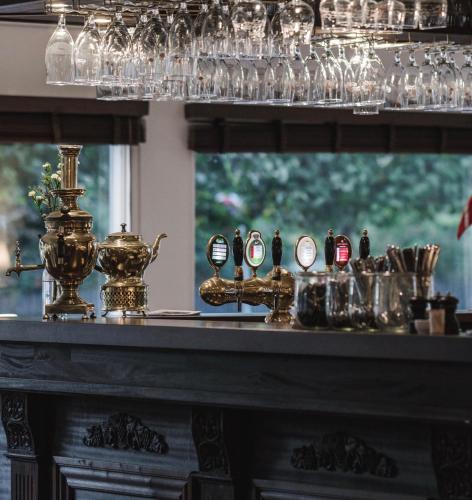 a bar with glasses and other items on a mantle at Hotel Gilleleje Strand in Gilleleje