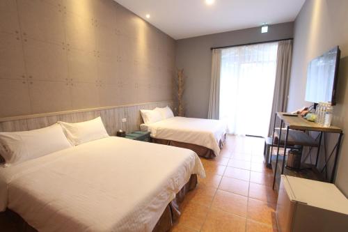 Ein Bett oder Betten in einem Zimmer der Unterkunft Jing Lai Hui Lan Homestay