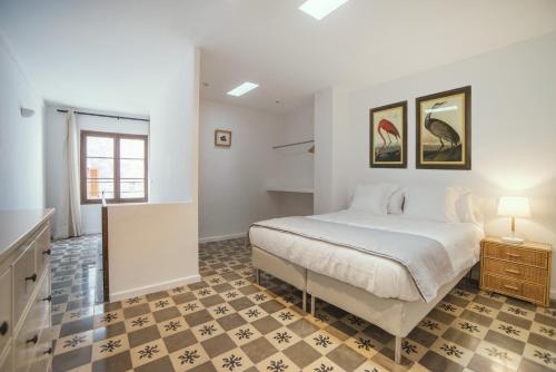 a bedroom with a bed and a checkered floor at Canavall in Palma de Mallorca