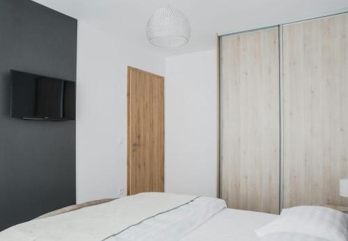 a bedroom with a bed and a wooden cabinet at Apartament 4Tourists in Braşov