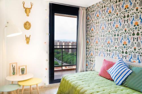バレンシアにあるApartUP Levante Skylineのベッドルーム1室(ベッド1台、テーブル、窓付)