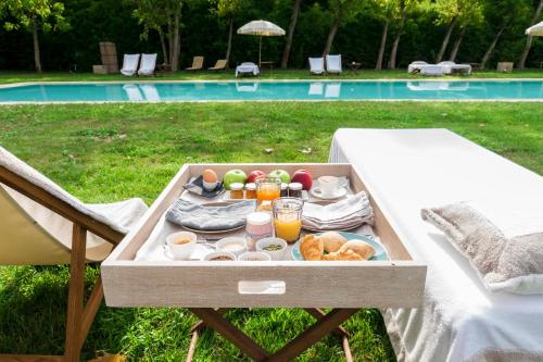 a tray of food on a table next to a pool at La Barchessa di Villa Pisani in Lonigo