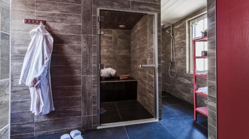 a bathroom with a shower with a glass door at Hotel Les Bois Flottais in Le Bois-Plage-en-Ré