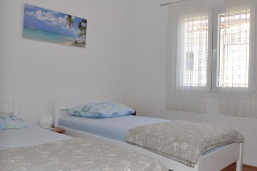 Ein Bett oder Betten in einem Zimmer der Unterkunft BM Apartments Rogoznica