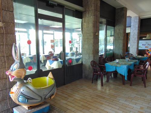 a restaurant with a rabbit statue in front of a table at Mr Jackpot2 in Canelli