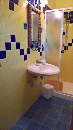 a bathroom with a sink and a mirror at Casa Vacanze La Caprignola in Buccino