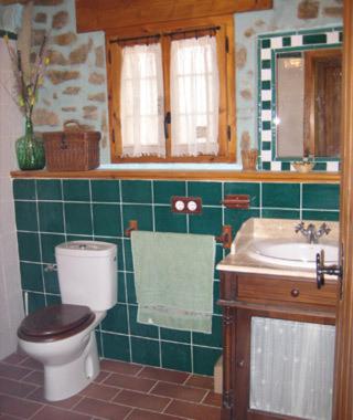 a bathroom with a toilet and a sink at La Casa Del Llano in Olocau del Rey