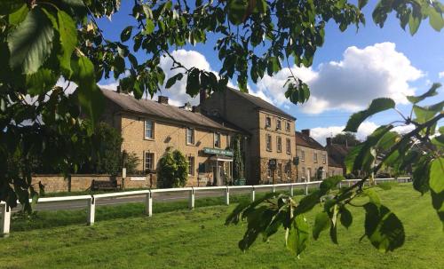 a building on the side of a road at Worsley Arms Hotel in Hovingham