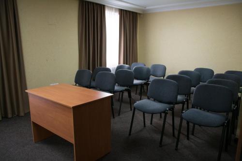 a room with a row of chairs and a podium at UYUTNYY DOM in Taraz