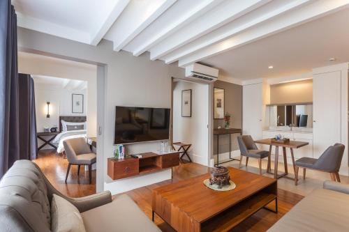 a living room with a couch and a table at Marine Beach Hotel Pattaya - SHA Plus in Jomtien Beach