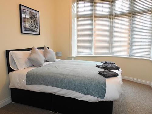a bedroom with a large bed in front of a window at Parks Nest 1 in Hull