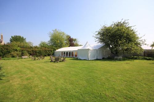 a tent in a field with tables and chairs at Worsley Arms Hotel in Hovingham