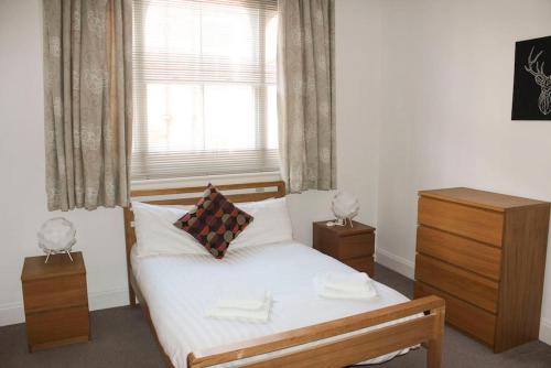 a small bedroom with a bed and a window at Princes Dock Chambers 3 in Hull