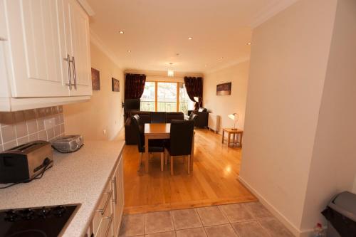 a kitchen and living room with a table and chairs at Assaroe Falls in Ballyshannon