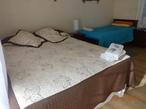 a bedroom with two beds with towels on them at Sentir Patagonia in Viña del Mar