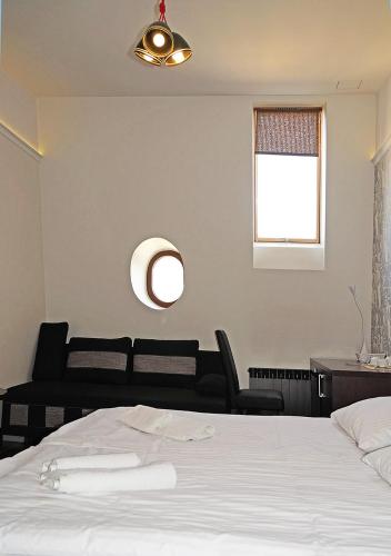 a bedroom with a white bed and a window at Aparthotel Łódź 55 Piotrkowska in Łódź