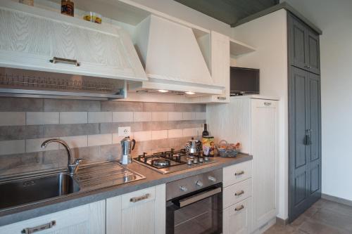 a kitchen with a sink and a stove top oven at Agriturismo Parco di Canuleio - con vista sul Lago in Bolsena