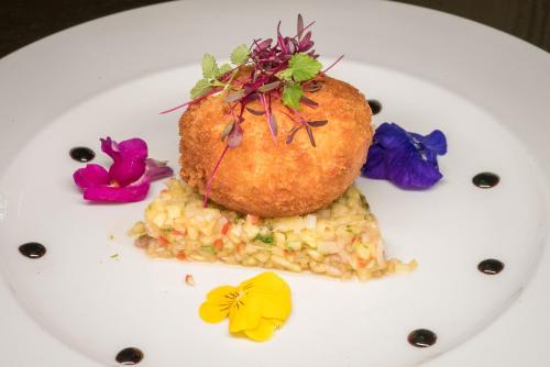 a plate of food with corn and flowers on it at Castle Bromwich Hall; Sure Hotel Collection by Best Western in Birmingham