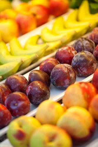 a display of different types of fruit on trays at JS Miramar in Can Picafort