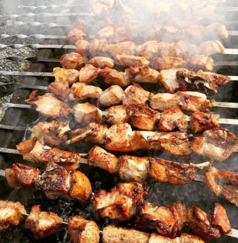 a bunch of food cooking on a grill at Guest House Kusika in Sighnaghi