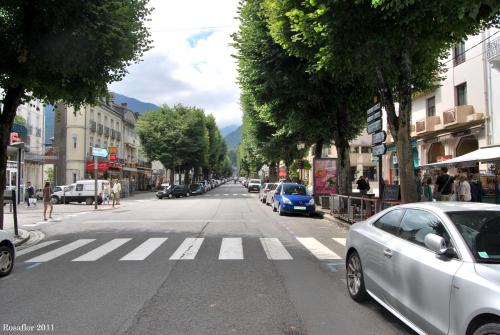 ulica miejska z samochodami zaparkowanymi po stronie drogi w obiekcie Appartement T2 w mieście Luchon