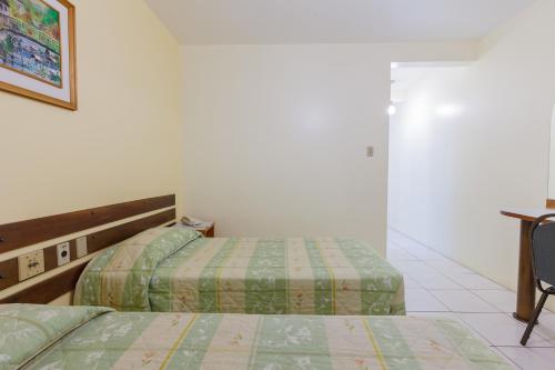 Postel nebo postele na pokoji v ubytování Tri Hotel Florianópolis