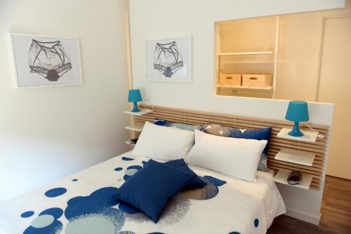 a bedroom with a bed with blue and white pillows at Le Rondinelle in Como