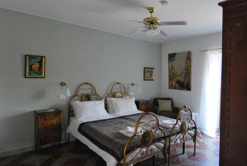 a bedroom with a bed and a ceiling fan at Art & Breakfast in Ripabottoni