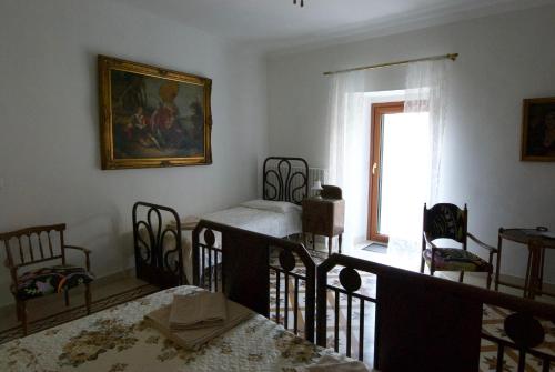 a living room with chairs and a painting on the wall at Art & Breakfast in Ripabottoni