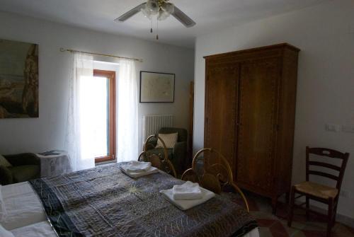 a bedroom with a table and chairs and a window at Art & Breakfast in Ripabottoni