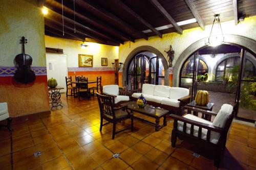 a living room with a couch and a table at Hotel Casa Colonial Boutique in Managua