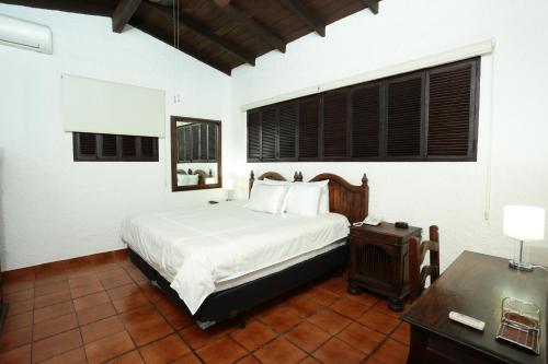 Llit o llits en una habitació de Hotel Casa Colonial Boutique
