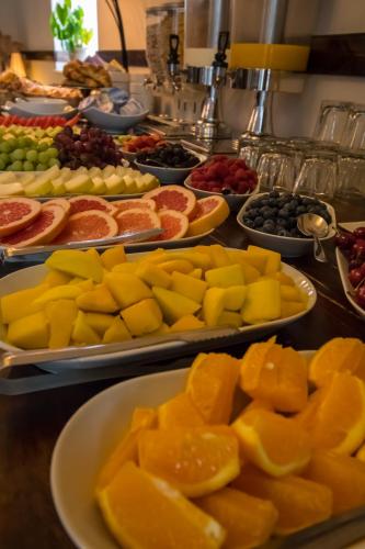 a buffet of fruits on plates on a table at A Park View Hotel in Wolverhampton