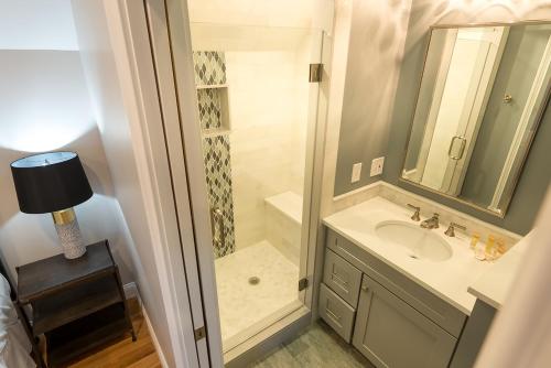 a bathroom with a shower and a sink at The Newport Lofts - 595 Thames Street in Newport