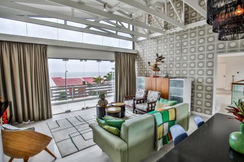 a living room with a couch and a table at Sea Dreams Guesthouse in Ballito