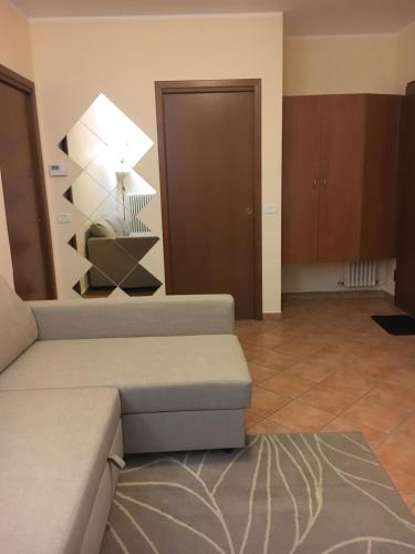 a living room with a couch and a lamp at Residence K.B. 2 in Fano