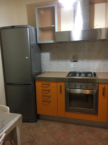a kitchen with a stove and a refrigerator at Residence K.B. 2 in Fano