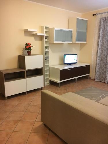 a living room with a couch and a television at Residence K.B. 2 in Fano