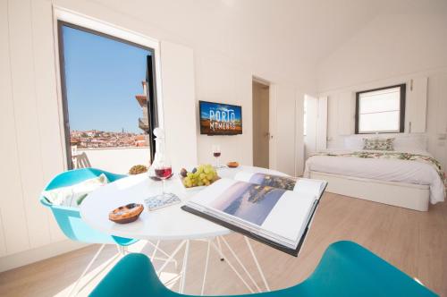 a white room with a table and chairs and a window at Porto Moments Apartments by Portugal Collection in Vila Nova de Gaia