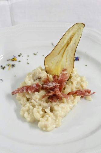 a plate of food with a serving of rice with a spoon at Hotel Fantelli in Folgarida