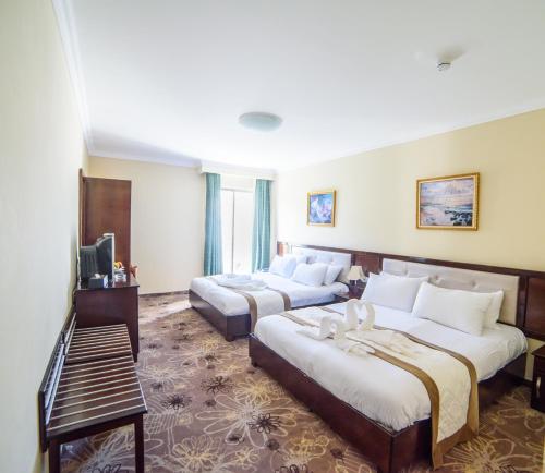 Postel nebo postele na pokoji v ubytování Sancta Maria Hotel