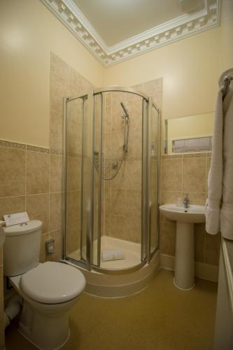 a bathroom with a shower and a toilet and a sink at A Park View Hotel in Wolverhampton