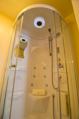 a bathroom with a shower with a toilet and a sink at A Park View Hotel in Wolverhampton