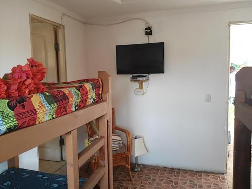 a bedroom with a bunk bed and a flat screen tv at Hotel Contadora in Contadora