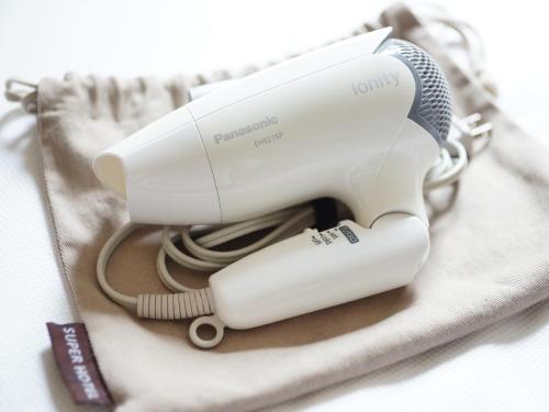 a hair dryer sitting on top of a towel at Super Hotel Shinyokohama in Yokohama