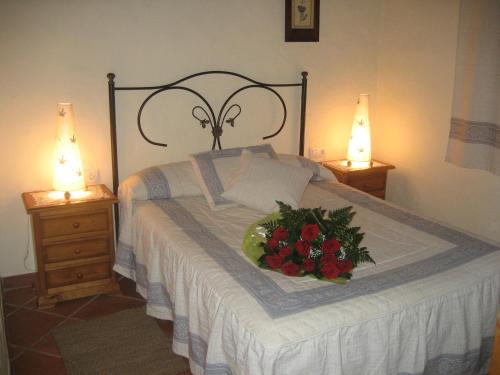 a bedroom with a bed with a bouquet of flowers on it at Camping Vejer in Vejer de la Frontera