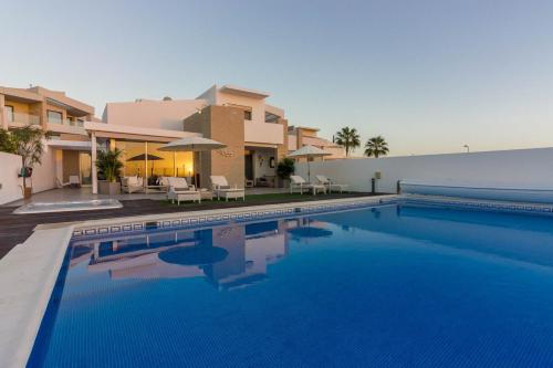 a swimming pool in front of a house at Villa White Whale in Adeje